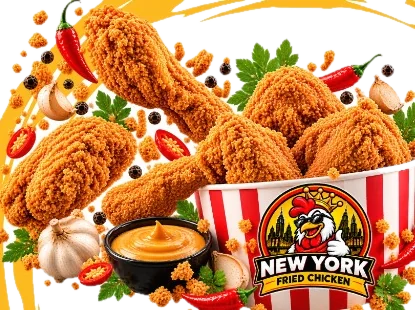 Crispy fried chicken pieces spilling out of a New York Fried Chicken bucket